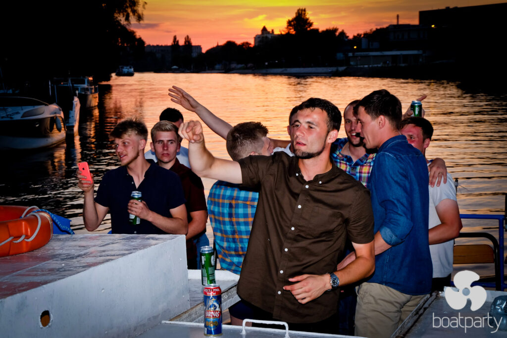 Stag do on a boat at sunset