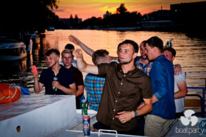 Stag do on a boat at sunset